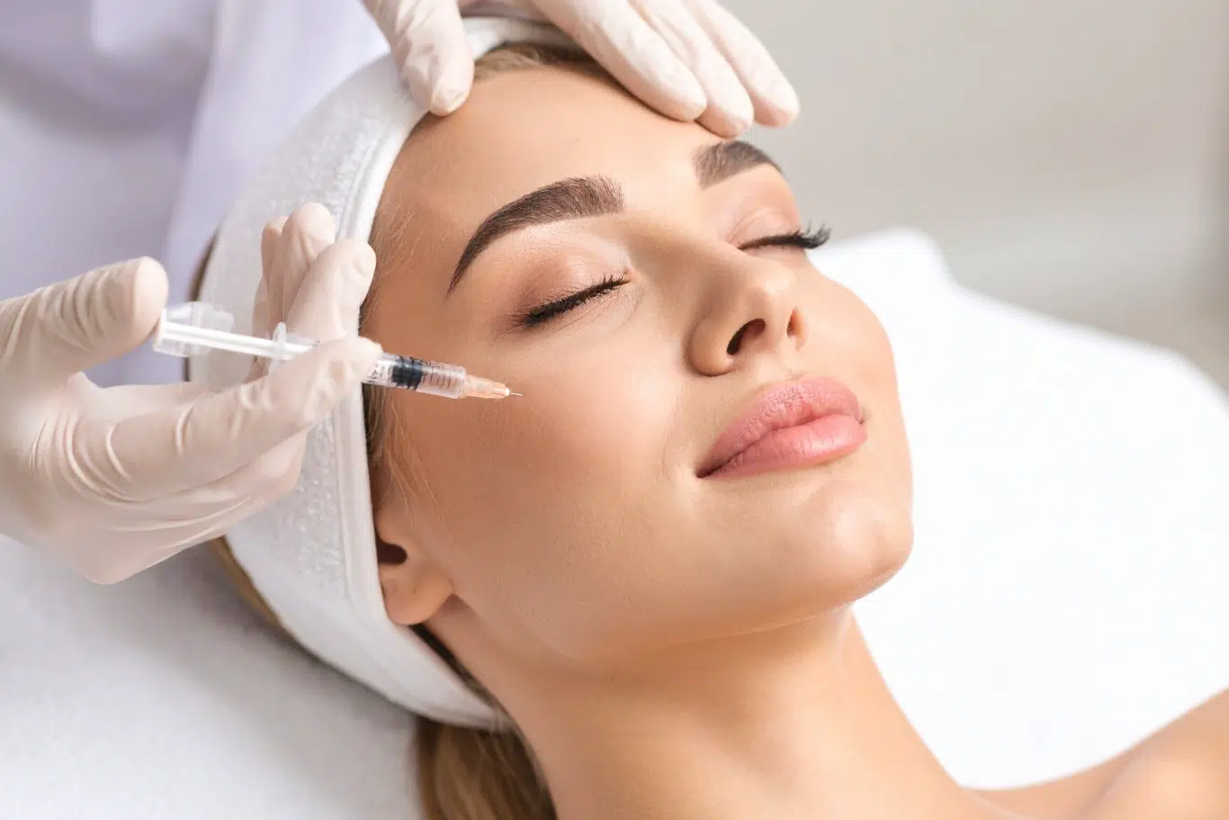 woman face having botox injection Woman receiving facial injection treatment at a medspa